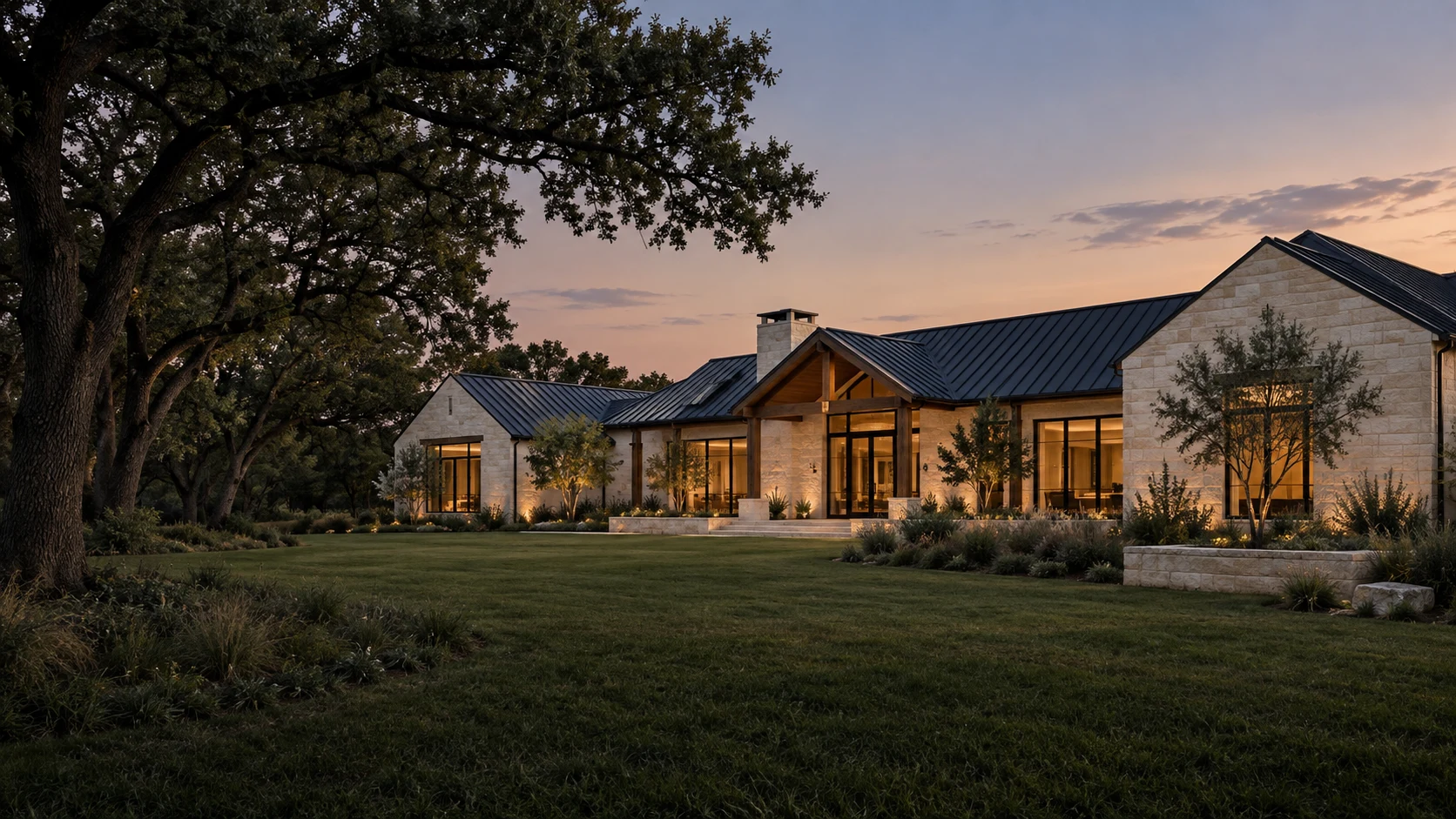 Modern Texas ranch concept with limestone, black metal roofs and native oaks